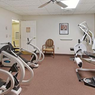 A small fitness room equipped with exercise machines like treadmills and stationary bikes.
