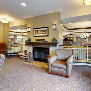A cozy living room with a fireplace and comfortable seating.