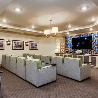 A cozy home theater with comfortable seating and a large TV.