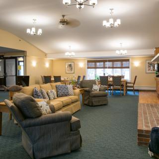 Spacious living room with comfortable seating and warm lighting.