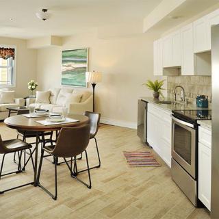 A modern open floor plan kitchen and living room with a dining area.