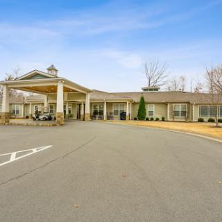A welcoming entrance of a commercial building with a spacious parking area.