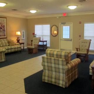 A cozy living room with plaid furniture and soft lighting.