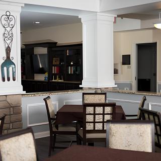 A cozy dining area with elegant tables and chairs, featuring tasteful decor.