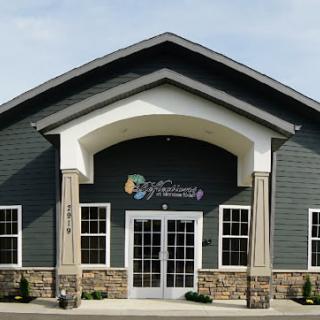 A commercial building with a prominent entrance and arched roof design.