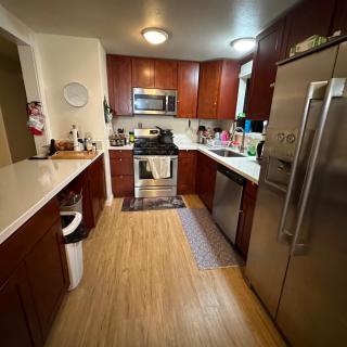 A modern kitchen with wooden cabinets and stainless steel appliances.