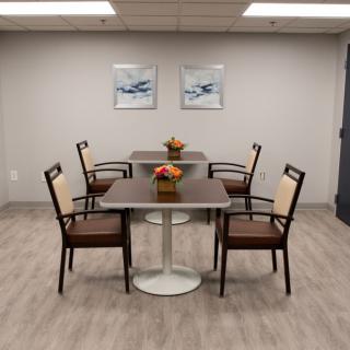 A modern conference room with a meeting table, chairs, and decorative flowers.
