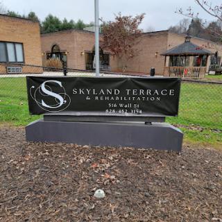 Sign for Skylane Terrace, a residential facility, set in a landscaped area.
