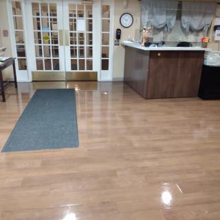 A clean lobby area with a reception desk and double doors.