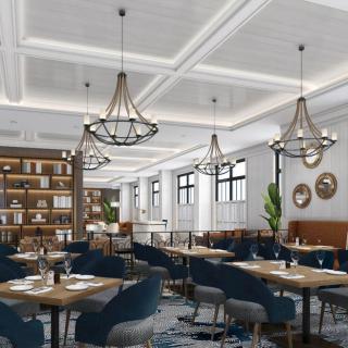 A modern restaurant interior with elegant chandeliers and cozy seating.