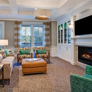 A cozy living room with a fireplace, television, and comfortable seating.