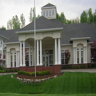 A large mansion with prominent columns and well-maintained landscaping.