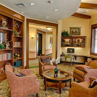 A cozy lobby area featuring comfortable seating and decorative bookshelves.