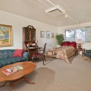 A cozy living space combining a bedroom and sitting area, featuring elegant furniture and tasteful decor.