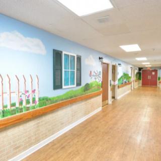 A brightly decorated hallway with a mural featuring painted windows and a scenic landscape.