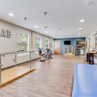A modern physical therapy room equipped with rehabilitation tools and exercise equipment.