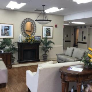 A warmly decorated lobby with comfortable seating, a fireplace, and various decorative elements.