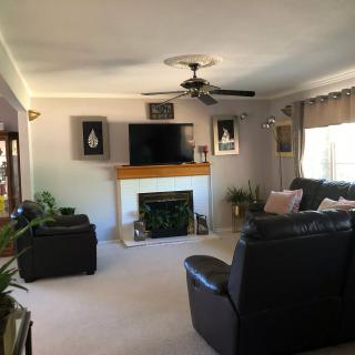 A cozy living room with a fireplace, TV, and comfortable seating.