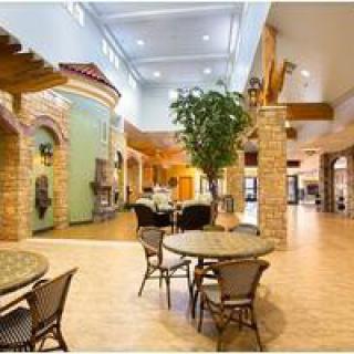 Spacious interior with seating area featuring tables, chairs, and decorative elements.