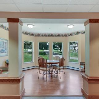 A cozy dining area with large windows allowing natural light to fill the space.