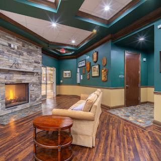 A cozy living room featuring a stylish stone fireplace and modern decor.