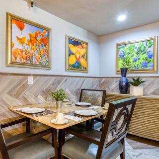 Cozy dining area with vibrant artwork and elegant table setting.