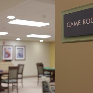 A cozy game room with tables and chairs, ready for activities.