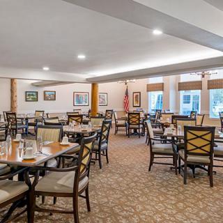An elegant dining area with neatly arranged tables and chairs.