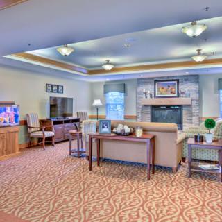 A cozy living room with comfortable seating, a television, and a fireplace.