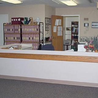 An administrative office with a reception desk and organized file storage.