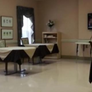 An empty dining room with tables and chairs arranged neatly.