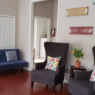 A cozy living room with comfortable seating and decorative elements.