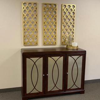 A stylish wooden cabinet adorned with decorative wall panels above it.