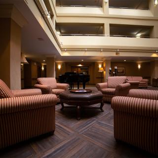 A cozy hotel lobby with comfortable seating and warm lighting.