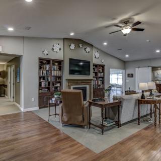 A cozy and modern living room with a fireplace and built-in bookshelves.