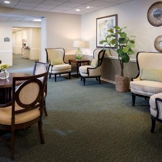 A comfortable and stylish lobby area featuring elegant furniture and decorative plants.
