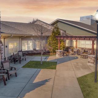 A serene courtyard with outdoor seating at sunset.