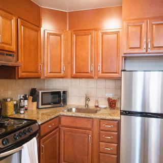Modern kitchen with wooden cabinets and stainless steel appliances.