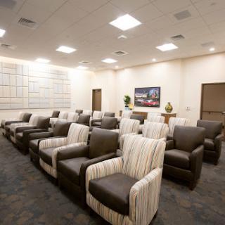 A modern waiting room featuring comfortable chairs arranged for relaxation.