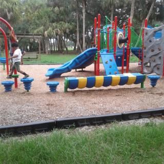 Children enjoying a vibrant and fun-filled playground with various play equipment.