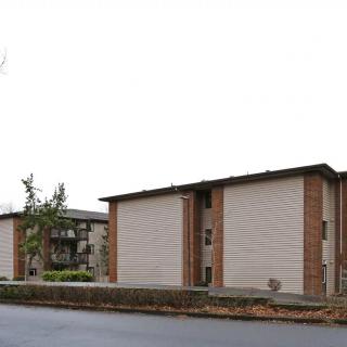 A view of two apartment buildings in a residential area.