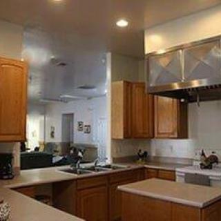 A modern kitchen with wooden cabinets and ample countertop space.
