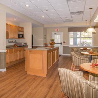 A modern open-concept kitchen and dining area with wood flooring and stylish furnishings.