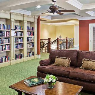 A cozy library corner with a comfortable sofa and bookshelves.