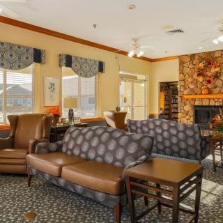 A cozy living room with comfortable seating and a warm fireplace.