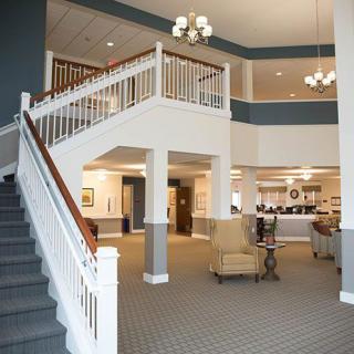 A spacious hotel lobby with a grand staircase and elegant lighting.