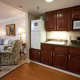 A cozy living space with a kitchenette and seating area.
