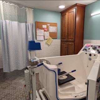 A rehabilitation therapy room equipped with specialized medical equipment.