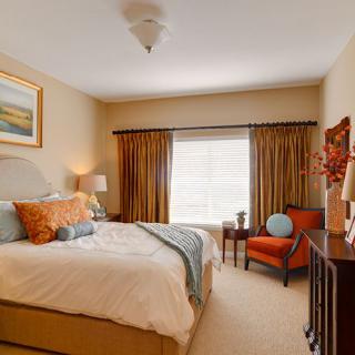 A cozy and elegantly designed bedroom with warm colors and tasteful decor.