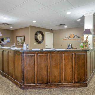 A well-organized reception area with a wooden desk and elegant decor.